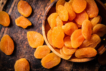 Wall Mural - A bunch of dried apricots on a plate and on the table. 