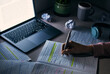 © Jordan C/peopleimages.com - Student, hands and writing notes at night with laptop for research, education and internet project. Closeup of college people, reading and write homework at dark desk for maths, studying and learning