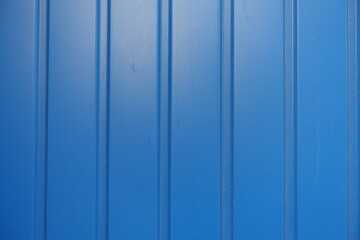Wall Mural - Close shot of electric blue wall with plastic siding