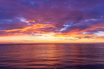 view at sunrise or sunset in sea with nice beach , surf , calm water and beautiful clouds on a background of a sea landscape