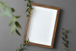 Blank portrait picture frame mockup with green plant decoration