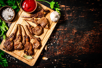 Poster - Grilled rack of lamb on a cutting board with parsley and tomato sauce. 