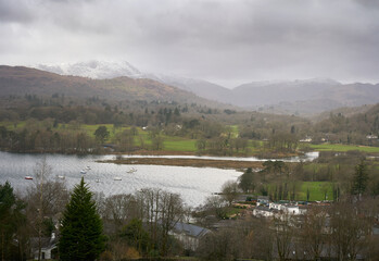 Poster - Clappersgate and Waterhead on the shore of Lake Windermere with the summit of Wetherlam and Wynrose pass in the distance on a cold winters morning in the Lake District Cumbrian Mountains, England, UK.