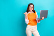 © deagreez - Photo of online education advert promo young lady direct finger look mockup hold laptop open new courses isolated on aquamarine color background