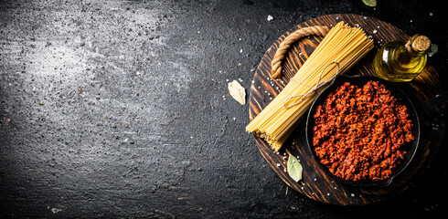 Wall Mural - Bolognese sauce on a wooden tray. 