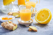 © Brebca - Homemade turmeric lemon ginger shots in small glasses