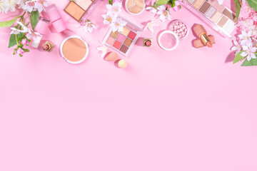 Wall Mural - Spring professional makeup flat lay. Spring make up set on pink background. Different make-up cosmetics, beauty accessories flat lay with spring blossom flowers top view copy space