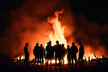Crowd Of People In Silhouette Watching Easter Fire Or Bonfire. Generative AI.