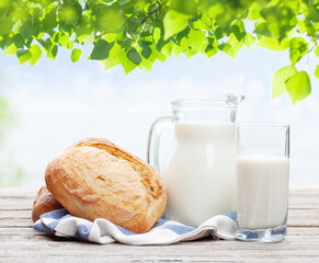 Poster - Homemade bread and milk on wooden table