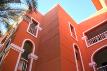 Fragment Corner Of Red Brick House, Resort Hotel Exterior, Palm Tree Under Blue Sky