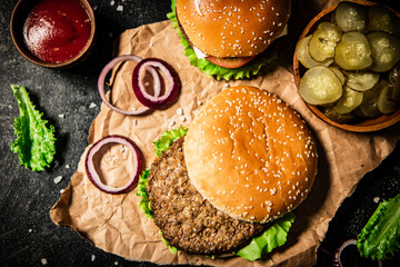 Sticker - Delicious burger with lettuce leaves and onion rings. 