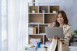 © ArLawKa - Successful Asian businesswoman receiving good news and excited with laptop computer at work.