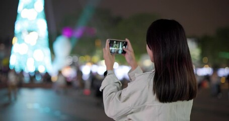 Sticker - Woman use mobile phone to take photo for christmas decoration at outdoor