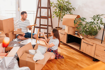 Wall Mural - Couple installing new furniture while moving in together