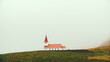 Beautiful landscape of the white church standing alone on the field in calm morning, in the fog.