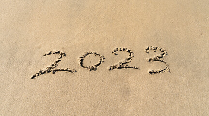 Wall Mural - 2023 hand written in sand on a beautiful beach