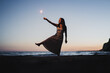 © ADDICTIVE STOCK - Happy woman with burning sparklers