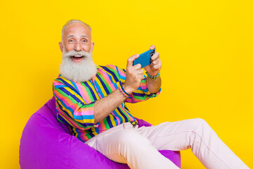 Sticker - Photo of sweet impressed guy dressed striped shirt watching soccer modern device empty space isolated yellow color background