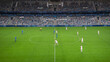 © Gorodenkoff - Soccer Football Championship Stadium with Crowd of Fans: Blue Team Starts The Game With Kick Off, Beginning of International Tournament Finals. Sport Channel Broadcast Television Concept. High Angle.