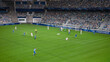 © Gorodenkoff - Soccer Football Championship Stadium with Crowd of Fans: Blue Team Attacks, Scores Goal, Players Celebrate Victory, Winners of Tournament. Sport Channel Broadcast Television. High Angle Wide Shot.