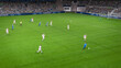 © Gorodenkoff - Soccer Football Championship Stadium with Crowd of Fans: Blue Team Forward Attacks, Dribbles, White Team Defending The Goals, Ready To Counterattack. Sports Channel TV Broadcast. High Angle.