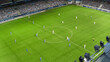 © Gorodenkoff - Soccer Championship Match on a Stadium full of Cheering Fans. Teams Play on Major League Football Tournament, Cup Broadcast. Sport Channel Television, Screen Content Concept. Aerial Drone Shot.