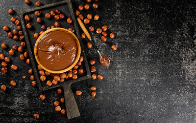 Canvas Print - Hazelnut butter on a cutting board with a spoon. 