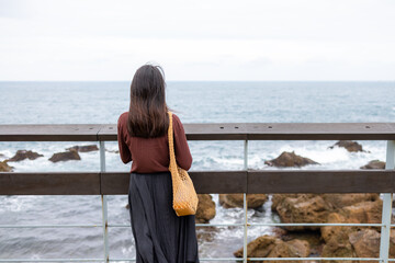 Wall Mural - Woman look at the sea beach