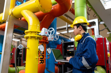 Wall Mural - Maintenance technician at a heating plant,Petrochemical workers supervise the operation of gas and oil pipelines in the factory,Engineers put hearing protector At room with many pipes