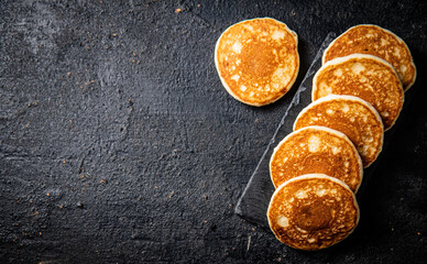 Sticker - Ready made homemade pancakes on a stone board. 