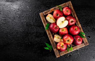 Wall Mural - Pieces and whole red apples on a wooden tray. 