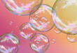 Colorful soap bubbles on a gradient orange-pink background. 3D template design 