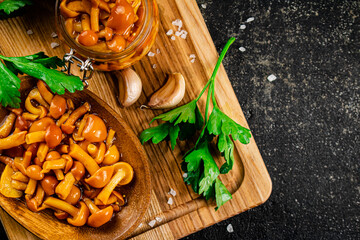 Canvas Print - Marinated mushrooms with parsley on a wooden cutting board. 