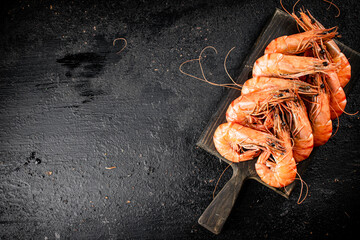 Sticker - Boiled shrimp on a cutting board. 