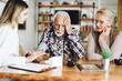 © Goran - Female nurse checking blood pressure of a senior man during her home visit