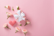 Valentine's Day Background. A Banner Layout With A Gift, Roses And Hearts On A Light Pink Background With A Space For Text.