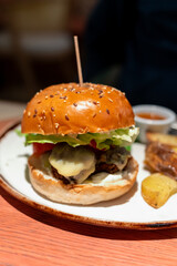 Wall Mural - Organic vegetarian burger with plant based falafel balls, vegan cheese, green lettuce and baked potatoes