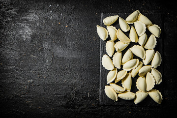 Wall Mural - Homemade potato dumplings on a stone board. 