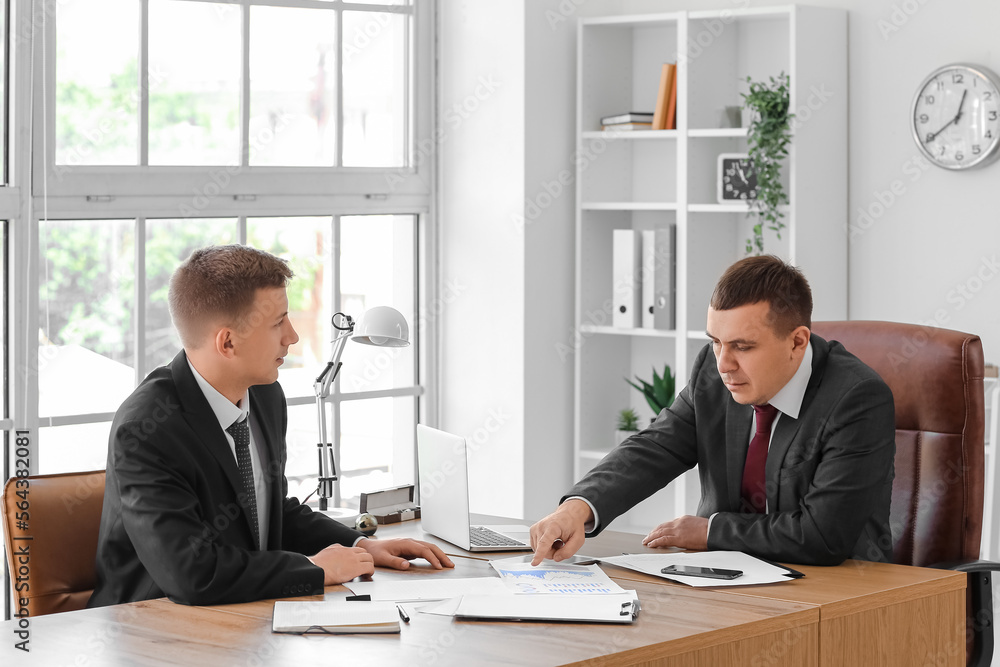 Business men working with documents at table in office