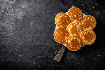 Wall Mural - Homemade pancakes in a plate on the table.