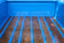 Loading Area Of A Restored Pickup Truck In Blue With A Shiny Wooden Floor