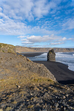 Dyrhólaey (Dyrholaey, Door Hill Island, Cape Portland), Small Promontory Located On South Coast Of Iceland, Near Vik. Reynisfjara And Reynisdrangar As Seen From Dyrhólaey. Arnardrangur "Eagle Rock"