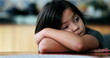 © Marco - Bored child with arms crossed leaning on table closeup face