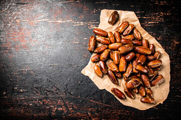 Canvas Print - A pile of dates on paper on the table. 