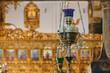 Candle in the interior of St. George Church. Ecumenical Patriarchate of Constantinople. Selected focus, defocused iconostasis at background. May 03, 2022. Fener, Istanbul, Turkey.