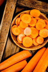 Wall Mural - Sliced fresh carrots. On a wooden background.