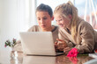 © FOTO_STOCKER - First love, young teens lovers couple studying laptop at home, boy and girl doing homework, first dating, flower and kids love.