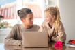 © FOTO_STOCKER - First love, young teens lovers couple studying laptop at home, boy and girl doing homework, first dating, flower and kids love.