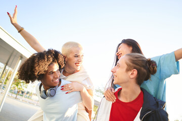 Wall Mural - Group of students on city street smiling. Young people having fun on vacation. High quality photo