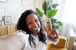 © CarlosBarquero - Attractive young woman using camera of smartphone taking funny selfie at home. High quality photo